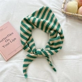Detailed close-up of green and cream striped knitted scarf with soft wool texture - Green Stripes