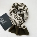 Detailed knit texture of green heart dot scarf with geometric pattern and ribbed edges - Olive Green