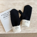 Close-up of black knit mittens with white fleece cuffs and branded Doria Dore label - Black