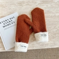 Detail of caramel knit mittens featuring plush white faux fur cuffs and soft fabric label - Orange