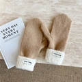 Detail of camel knit mittens with white plush cuffs and Doria Dore woven label - Camel