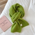 Close-up of bright green chunky knit scarf with vertical stripes on white fabric - Green