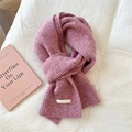 Close-up of pink knit scarf texture with DORIA DORE fabric label and wash tag - 21x165cm / Heather Deep Purple