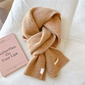 Close-up of orange and beige chunky knit scarf showing soft texture and brand label - 21x165cm / Heather Orange