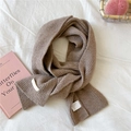 Detailed close-up of brown knit scarf showing thick ribbed texture and brand label - 21x165cm / Heathered Coffee