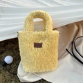 Detail of yellow plush tote bag showing teddy fleece texture and brown leather logo tag - Yellow (8HSM)