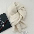 Detailed close-up of cream knitted scarf texture with fabric label and care tag - 20cmx150cm / White