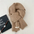 Detailed close-up of warm alpaca wool blend knit scarf with brand material tags - 20cmx150cm / Camel