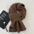 Detail of dark brown knitted wool scarf showing vertical rib texture and 100% wool label - 22*160cm / Brown