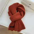 Detail of caramel wool scarf showing 100% wool label and ribbed knit texture - 22*160cm / Orange Red