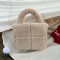 Detail of beige teddy fleece handbag showing soft cross-stitched texture and sturdy handle - Beige