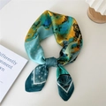 Abstract silk scarf with teal and mustard floral print tied in an elegant ring knot - Classic Beauty Art