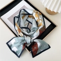 Light blue skinny silk scarf with yellow scrolls and red geometric patterns tied in a bow - Vintage Rope Pattern Light Blue