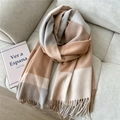 Detail of wool-touch plaid scarf with soft tassels on a grey fabric sofa surface - Wool Long Plaid Camel Gray