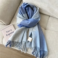 Close-up of blue and grey checkered wool scarf with soft tassels on a cozy sofa - Wool Plaid Dark Blue