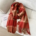 Close-up of red and orange plaid wool scarf with long tassels on a soft beige fabric - Wool Small Plaid Red