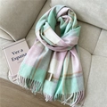 Detail of wool blend plaid scarf with mint green fringes on a cozy sofa - Wool Double Line Cyan