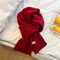 Detail of red 100% wool knitted scarf showing premium thick ribbed texture on white bed - Red - Black Label Style (22*160cm)