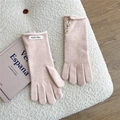 Detail of pink knitted gloves featuring decorative vintage buttons and a soft plush texture - One Size / Pink