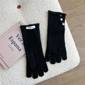 Detail of black knit gloves with three wooden buttons and white Doria Dore fabric label - One Size / Black