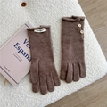 Close-up of coffee brown knitted gloves with vintage wood buttons and woven brand label - One Size / Dark Brown