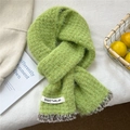 Detail of grass green knitted scarf with leopard print faux fur trim and white woven label - 20cmx152cm / Green