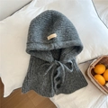 Close-up of dark grey knitted hood scarf with resin buttons and handmade label - Gray
