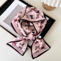 Pink silk scarf with colorful horse print tied in a bow on a black frame - Colorful Horses Group Pink