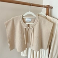 Detailed knit texture and tie-front knot closure on a beige minimalist knit shawl - Beige