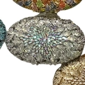 Macro shot of oval evening bags with sparkling crystals and starburst flower patterns - Silver AB