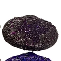 Macro shot of purple crystal-studded leaf pattern on luxury metal evening clutch bag - Deep purple