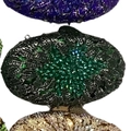 Close-up of luxury crystal clutch bags with starburst rhinestone patterns in various colors - Dark Green