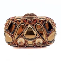 Macro view of luxury clutch bag featuring amber diamonds and geometric crystals - Gold Brown
