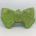 Close-up of emerald green bow evening clutch bag with luxury crystal rhinestones - Light Green
