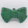 Macro shot of emerald green crystal evening bag featuring a radiant bow-knot shape design - Dark Green
