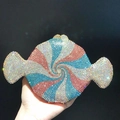 Detailed view of candy-shaped clutch with pink and blue rhinestones in spiral pattern - Light Blue Multi