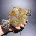 Detailed view of candy-shaped clutch bag with spiral gold and silver rhinestones - Gold