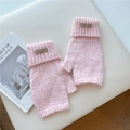 Detail of pink knitted fingerless gloves with soft texture and leather patch detail - One Size / Pink