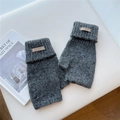 Detail of dark grey knit fingerless gloves with plush texture and leather logo patch - One Size / Dark Gray