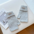 Close-up of grey knitted fingerless gloves with ribbed cuffs and leather label detail - One Size / Light Gray