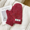 Close-up of thick red tweed knit mittens with decorative four-leaf clover woven label - Starry Green Flower Wine Red
