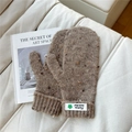 Close-up of tan knit mittens with colorful speckled fibers and white Fashion woven label - Starry Green Flower Coffee