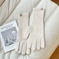 Detailed close-up of cream knit gloves with a leather brand tag and ribbed wrist cuffs - One Size / Cream