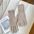 Close-up of light brown knitted gloves with ribbed cuffs and branded fabric label - One Size / Beige Coffee