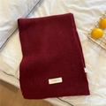 Thick dark red knitted winter scarf with white logo tag on soft white bedding background - 30x165cm / Foggy Red (Classic EST)