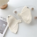 Detail showing white knitted texture and brand logo label on soft thermal gloves - One Size / Cream
