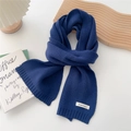 Detail of navy cashmere knit scarf with brand label on minimalist aesthetic background - Navy Blue