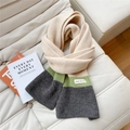 Close-up of tricolor knit scarf with cream, green and grey panels on white sofa - Beige/Green/Grey Color Block