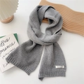 Detail of grey knitted cashmere scarf showing fine texture and ribbed edge finish - Light Gray