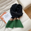 Detailed knit texture of a three-color block scarf in black, khaki and green on a sofa - Black/Khaki/Green Color Block